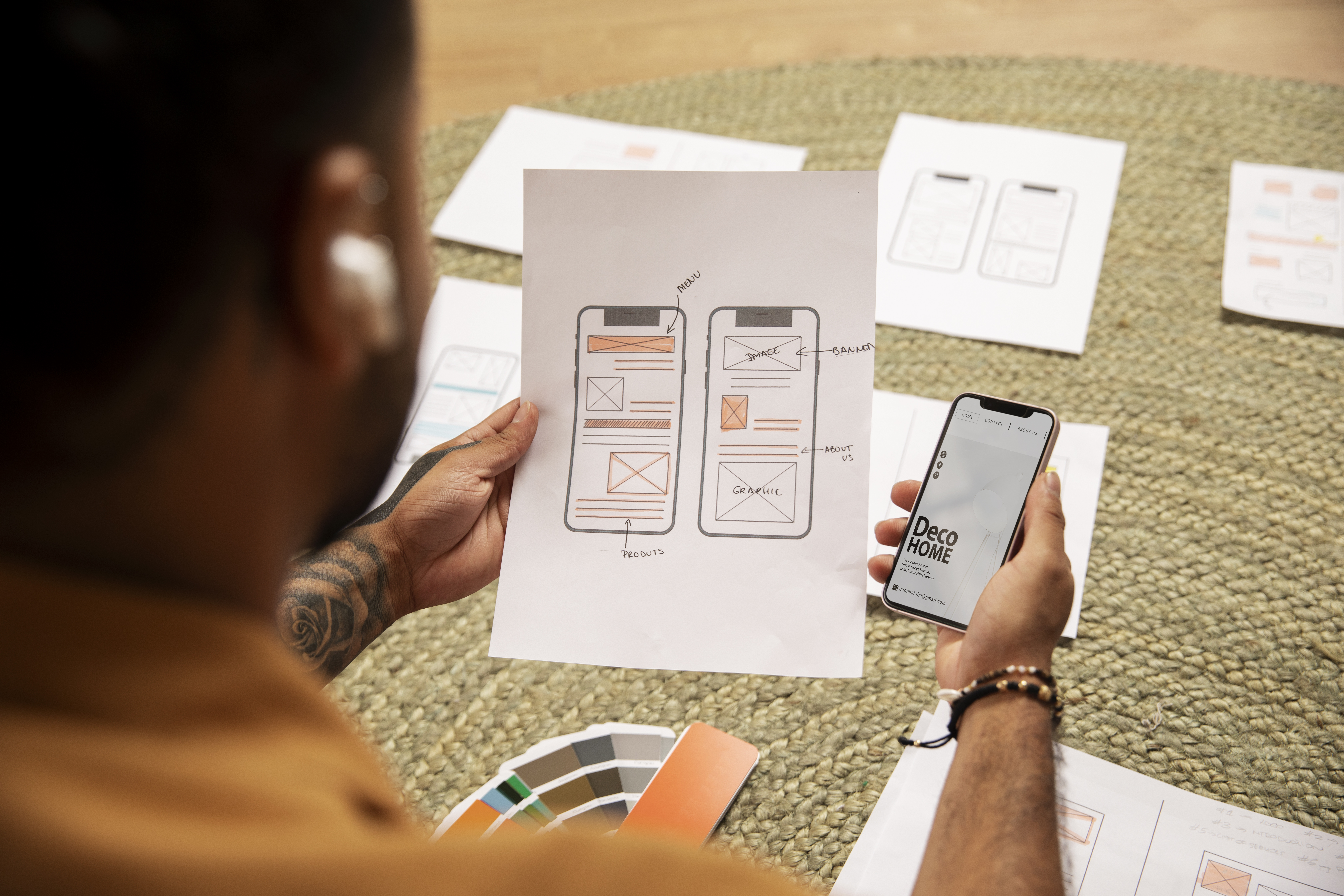 high-angle-designer-holding-smartphone high-angle-designer-holding-smartphone